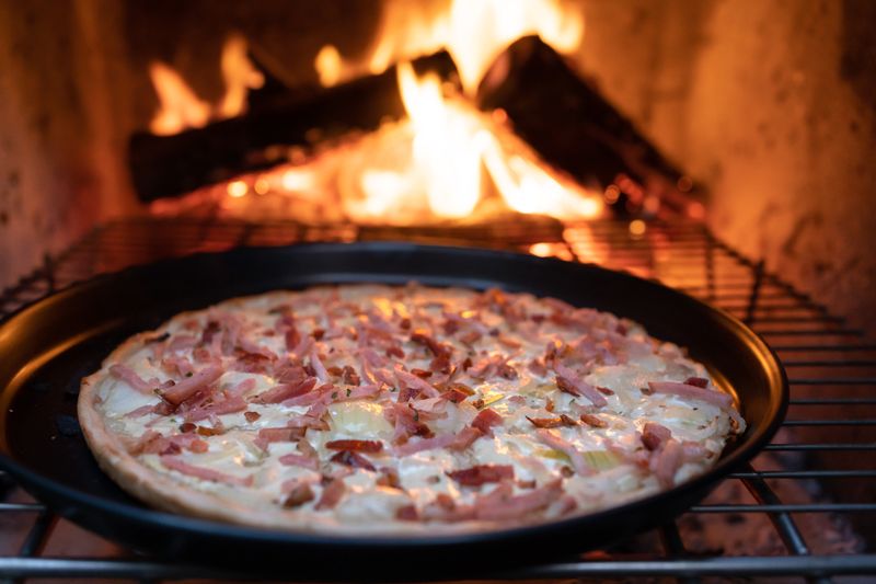 Wood-fired crust pizza with charred edges and rich toppings